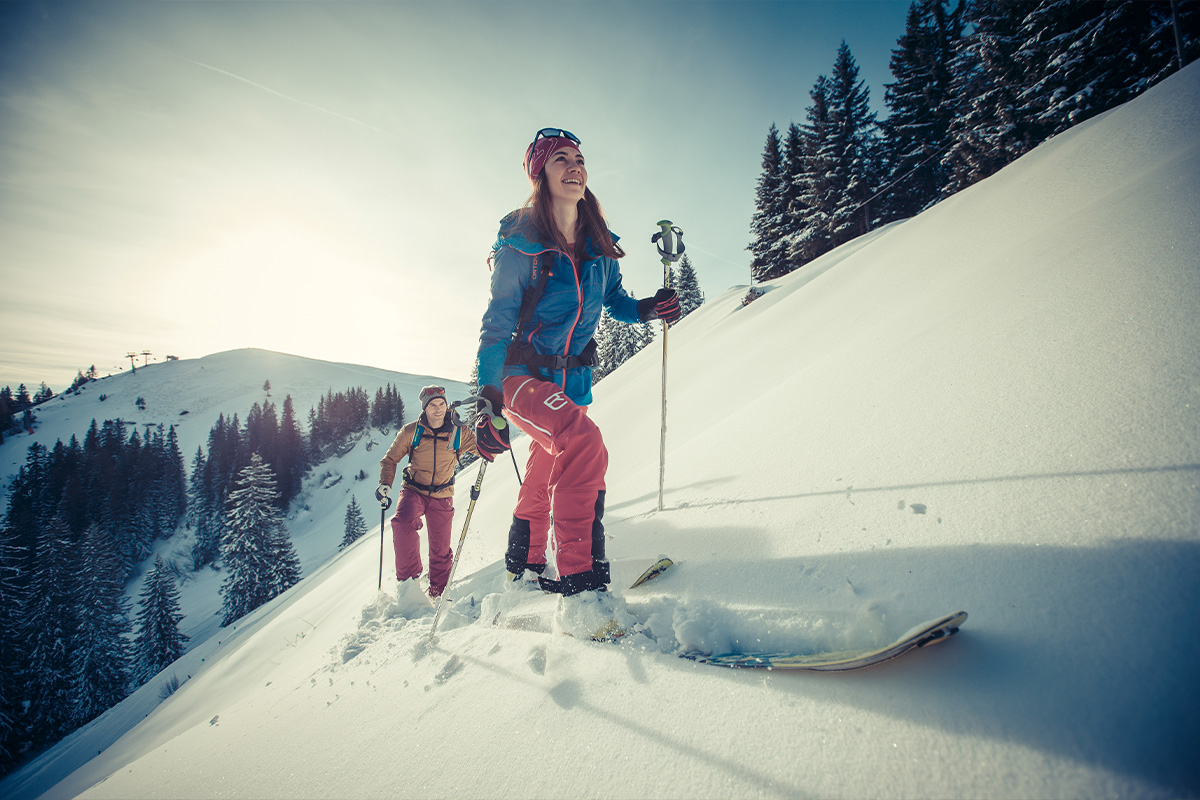 Zwei Ski-Langläufer bei Sonne in den Bergen